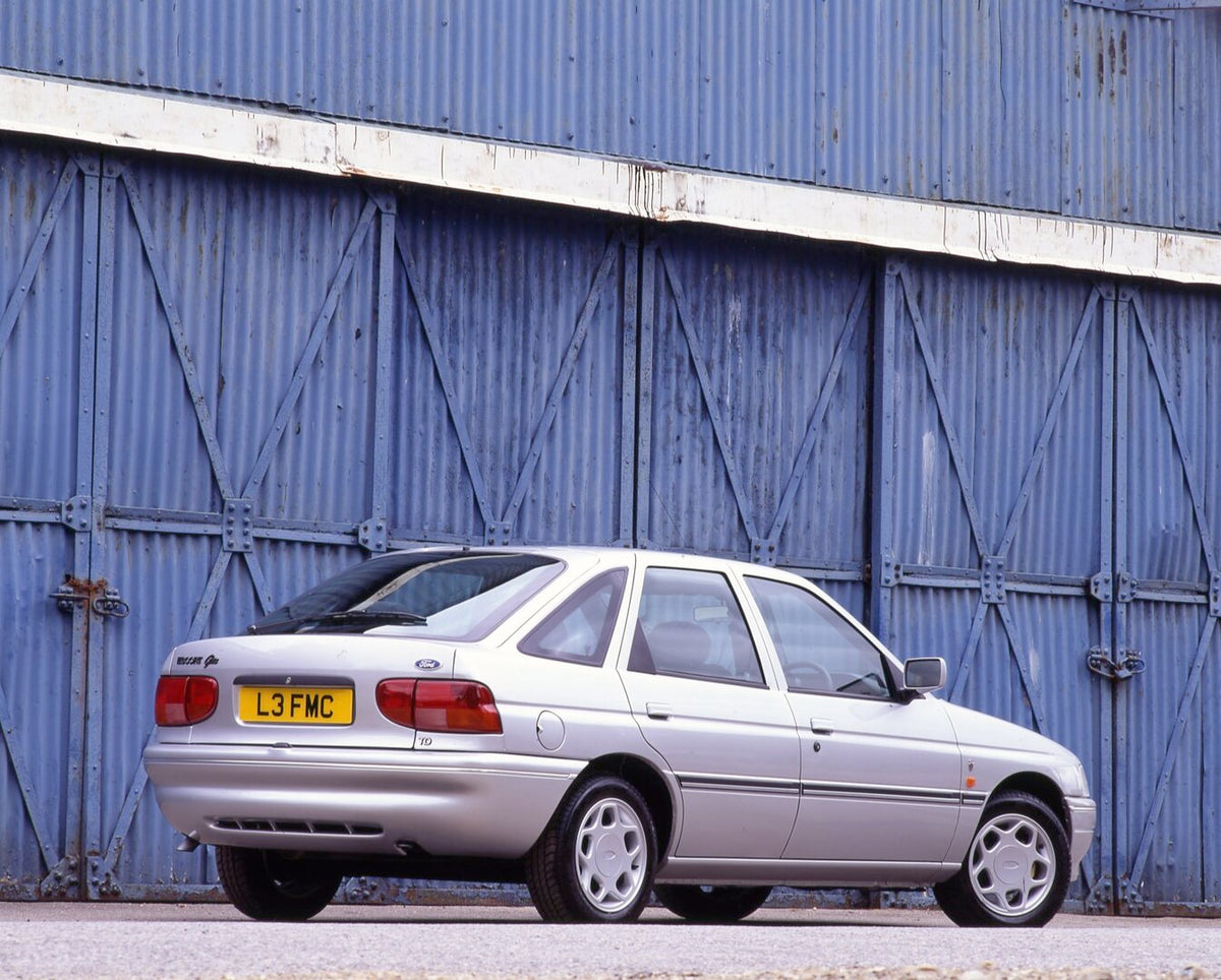 This archival image documents the 1993 Ford Escort Mark V Ghia rear view in front of blue wall and is preserved in the Ford Heritage Vault as part of Ford Motor Company's historic photographic archive. Free for personal, non-commercial use. Ford H...