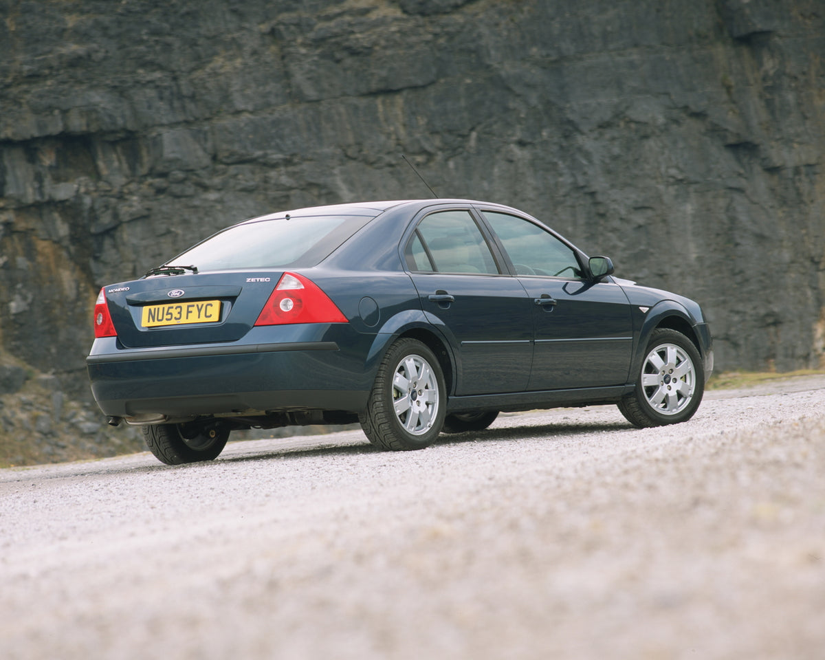 This archival image documents the 2003 Ford Mondeo Zetec Mark II rear view with scenic rock wall and is preserved in the Ford Heritage Vault as part of Ford Motor Company's historic photographic archive. Free for personal, non-commercial use. Ford...
