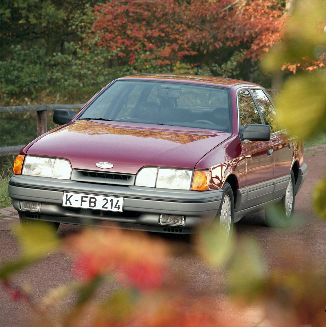 This archival image documents the 1986 Merkur Scorpio front closeup with scenic branches in Cologne and is preserved in the Ford Heritage Vault as part of Ford Motor Company's historic photographic archive. Free for personal, non-commercial use. F...
