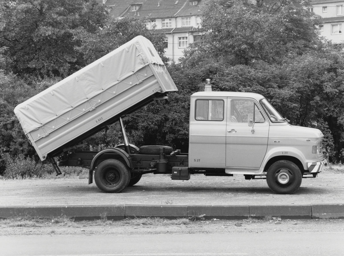 This archival image documents the 1970 Ford A-Series Truck with bed lifted on dirt road with scenic trees and is preserved in the Ford Heritage Vault as part of Ford Motor Company's historic photographic archive. Free for personal, non-commercial ...