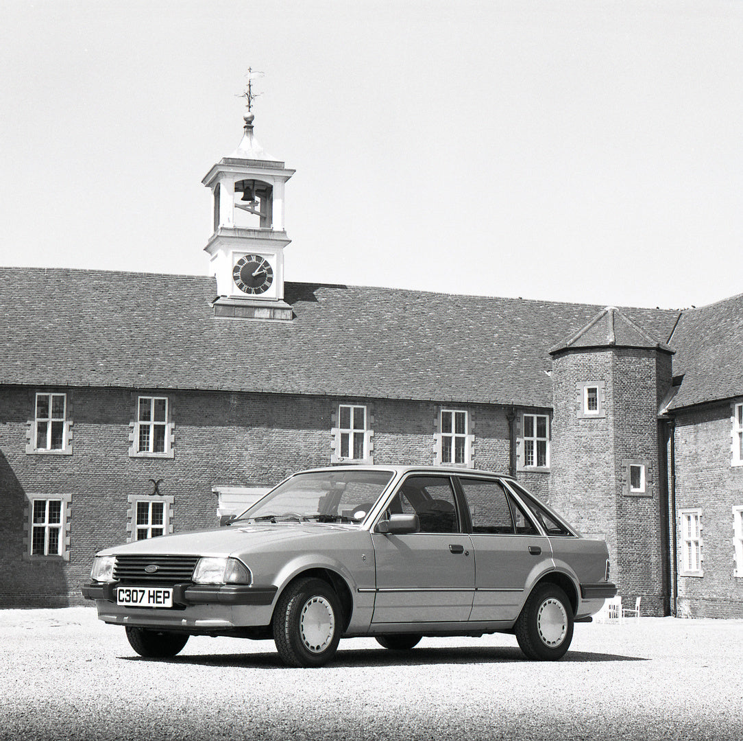 This archival image documents the 1985 Ford Escort Mark III Ghia in front of building with clock tower and is preserved in the Ford Heritage Vault as part of Ford Motor Company's historic photographic archive. Free for personal, non-commercial use...