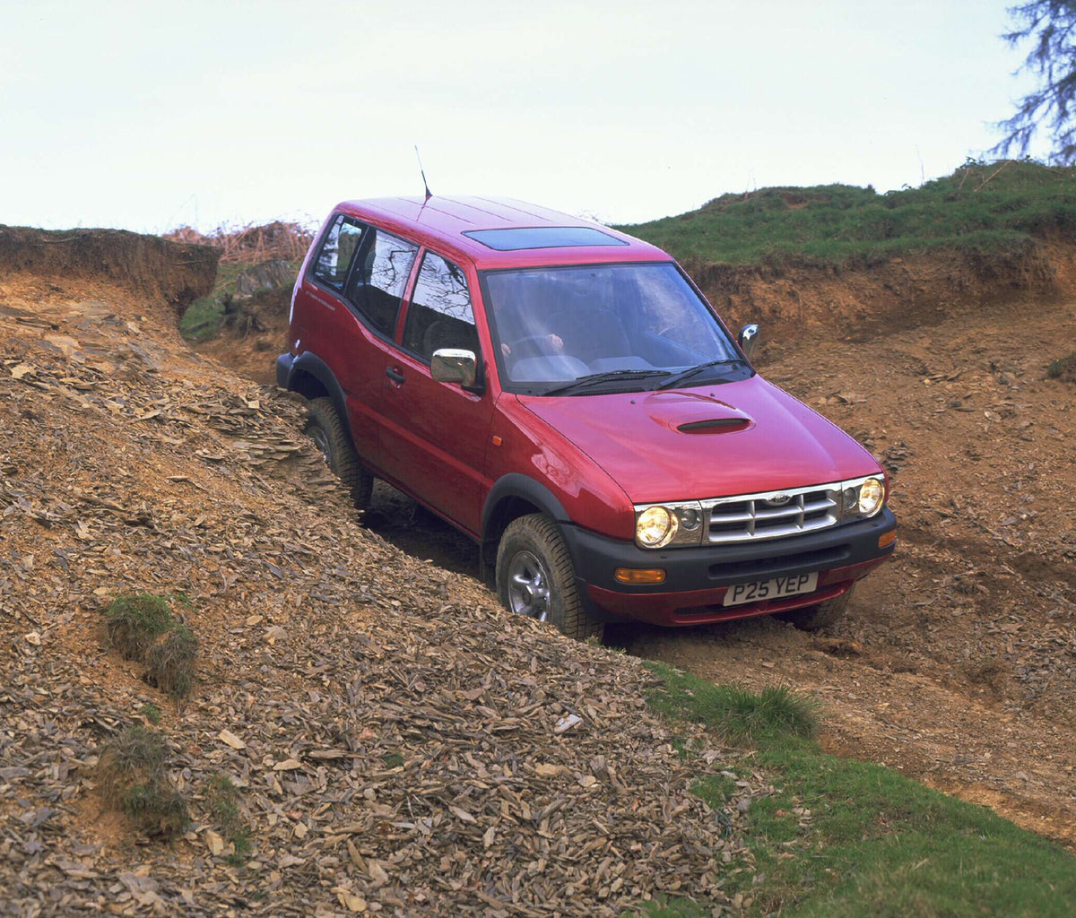 This archival image documents the 1997 Ford Maverick GLS on scenic dirt road AR-2002-213709 and is preserved in the Ford Heritage Vault as part of Ford Motor Company's historic photographic archive. Free for personal, non-commercial use. Ford Heri...