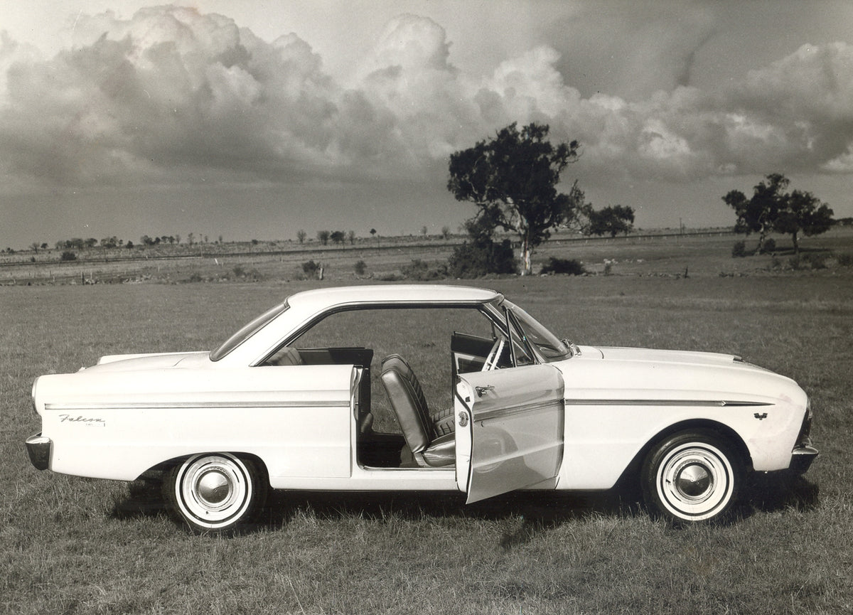 This archival image documents the 1964 Ford XM Falcon 2 Door Hardtop side view with open doors in scenic field and is preserved in the Ford Heritage Vault as part of Ford Motor Company's historic photographic archive. Free for personal, non-commer...