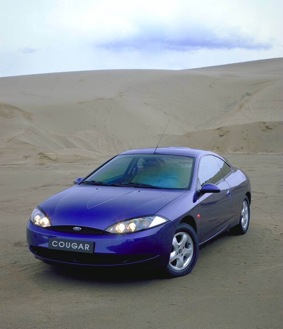 This archival image documents the 1998 Ford Cougar in scenic desert AR-2002-213709 and is preserved in the Ford Heritage Vault as part of Ford Motor Company's historic photographic archive. Free for personal, non-commercial use. Ford Heritage Vaul...