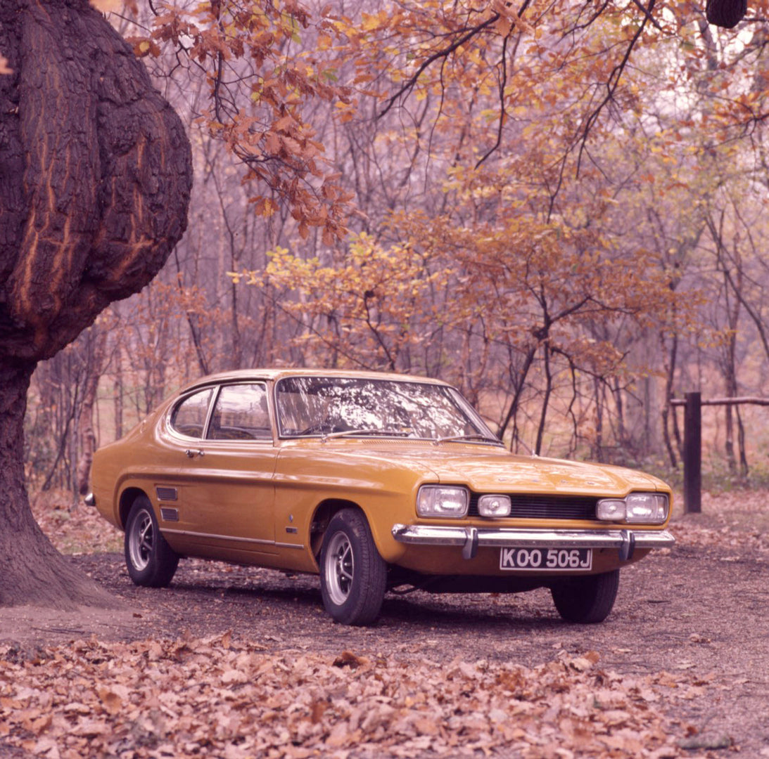 This archival image documents the 1970 Ford Capri MK I 2000 GT with scenic trees in autumn and is preserved in the Ford Heritage Vault as part of Ford Motor Company's historic photographic archive. Free for personal, non-commercial use. Ford Herit...