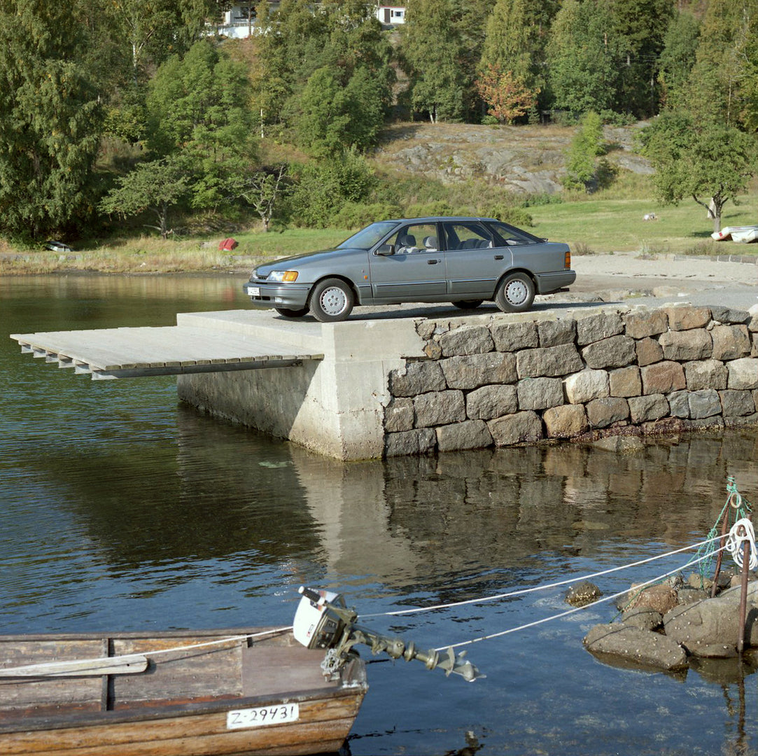 This archival image documents the 1986 Ford Granada Mark III Ghia on scenic stone dock in Norway and is preserved in the Ford Heritage Vault as part of Ford Motor Company's historic photographic archive. Free for personal, non-commercial use. Ford...