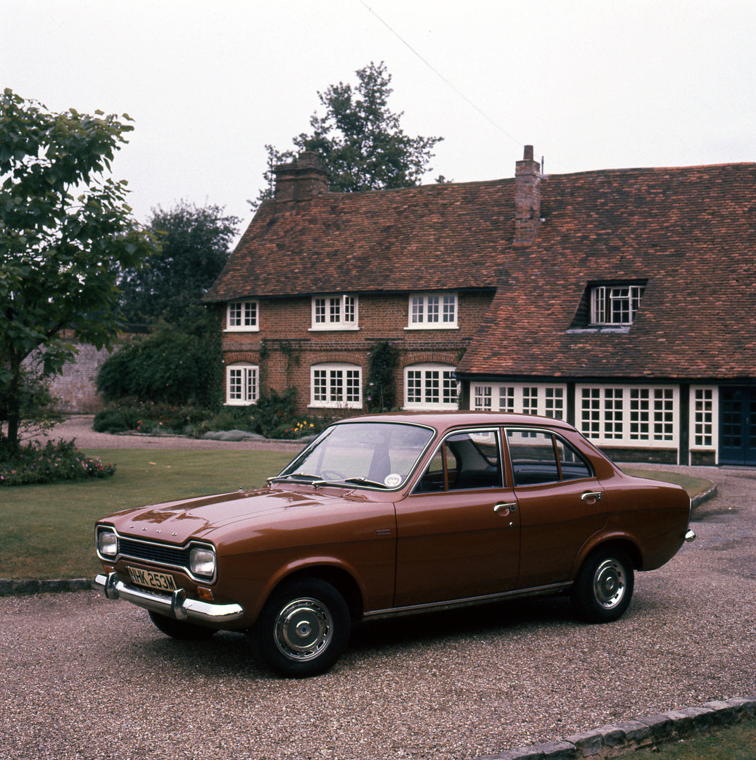 This archival image documents the 1974 Ford Escort Mark I 1300 XL in front of scenic house and is preserved in the Ford Heritage Vault as part of Ford Motor Company's historic photographic archive. Free for personal, non-commercial use. Ford Herit...