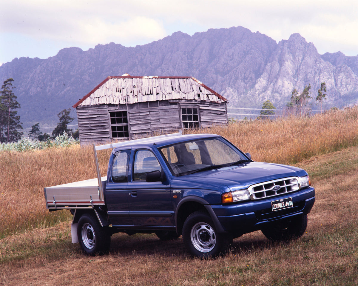 This archival image documents the 1999 Ford Courier 4WD Pickup Truck Driver Side Front End View in a Field FAP-2011-3 and is preserved in the Ford Heritage Vault as part of Ford Motor Company's historic photographic archive. Free for personal, non...