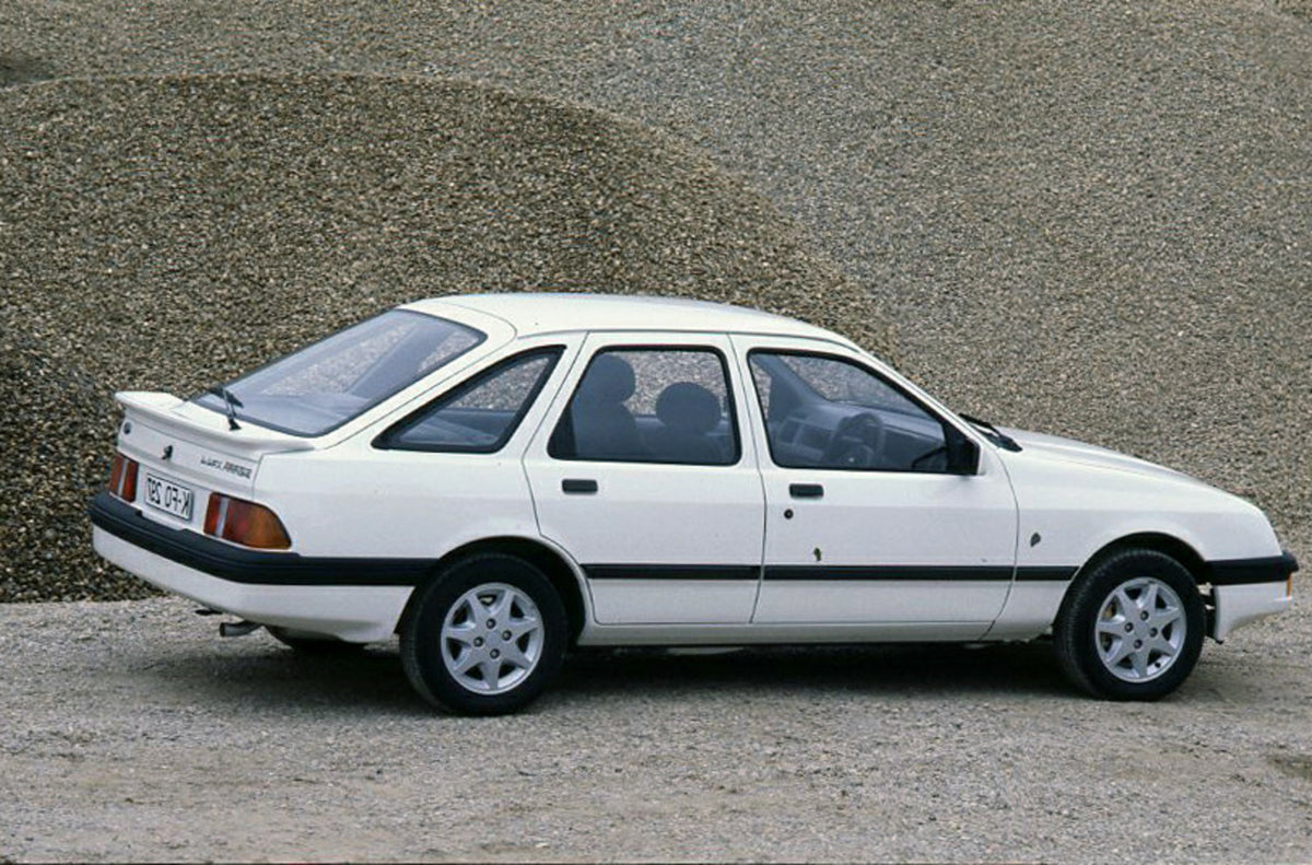 This archival image documents the 1985 Ford Sierra XR 4x4 LHD rear view in gravel pit and is preserved in the Ford Heritage Vault as part of Ford Motor Company's historic photographic archive. Free for personal, non-commercial use. Ford Heritage V...