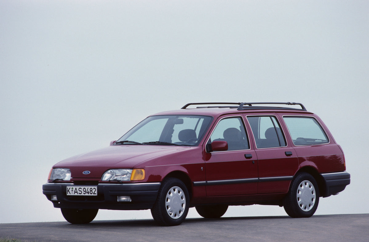 This archival image documents the 1987 Ford Seria 2.0 Ghia with scenic blue sky and is preserved in the Ford Heritage Vault as part of Ford Motor Company's historic photographic archive. Free for personal, non-commercial use. Ford Heritage Vault r...