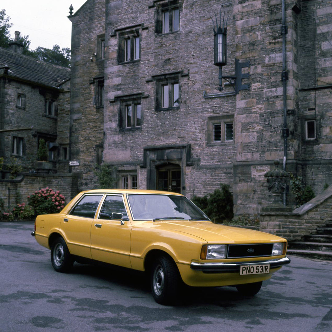 This archival image documents the 1976 Ford Cortina MK IV 1.6 L in front of scenic building and is preserved in the Ford Heritage Vault as part of Ford Motor Company's historic photographic archive. Free for personal, non-commercial use. Ford Heri...