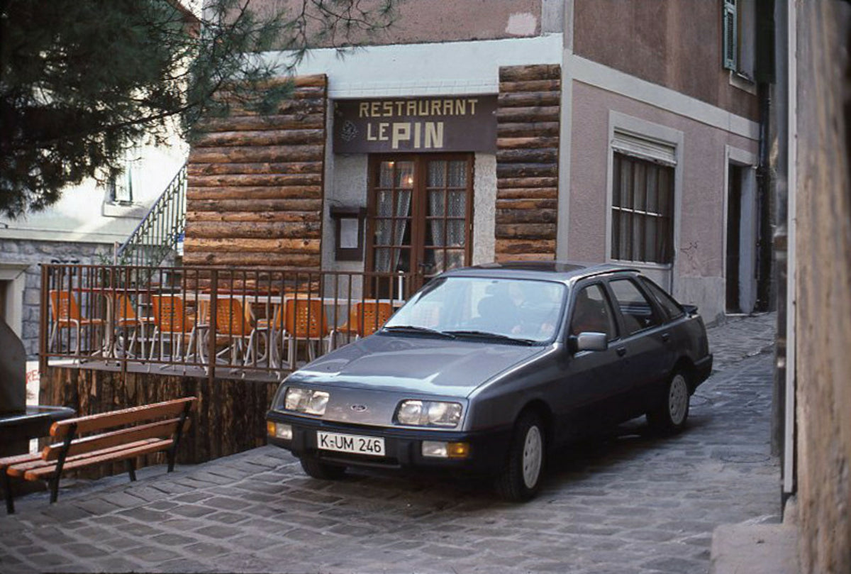 This archival image documents the 1985 Ford Sierra 2.0 IS LHD in front of Restaurant Le Pin and is preserved in the Ford Heritage Vault as part of Ford Motor Company's historic photographic archive. Free for personal, non-commercial use. Ford Heri...