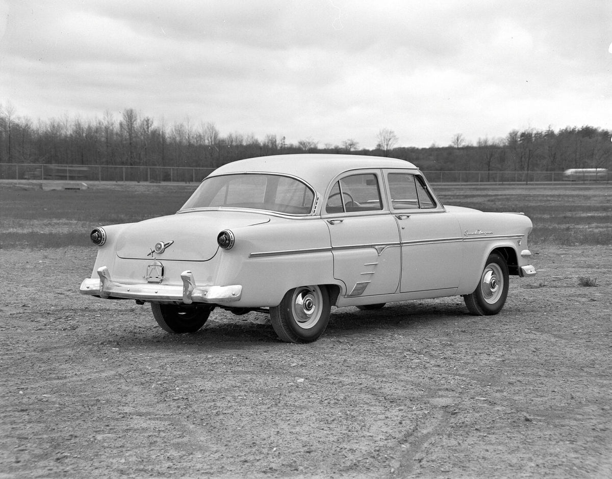 This archival image documents the 1954 Meteor Niagara Sedan rear view on dirt road with scenic trees AR-2007-5 and is preserved in the Ford Heritage Vault as part of Ford Motor Company's historic photographic archive. Free for personal, non-commer...