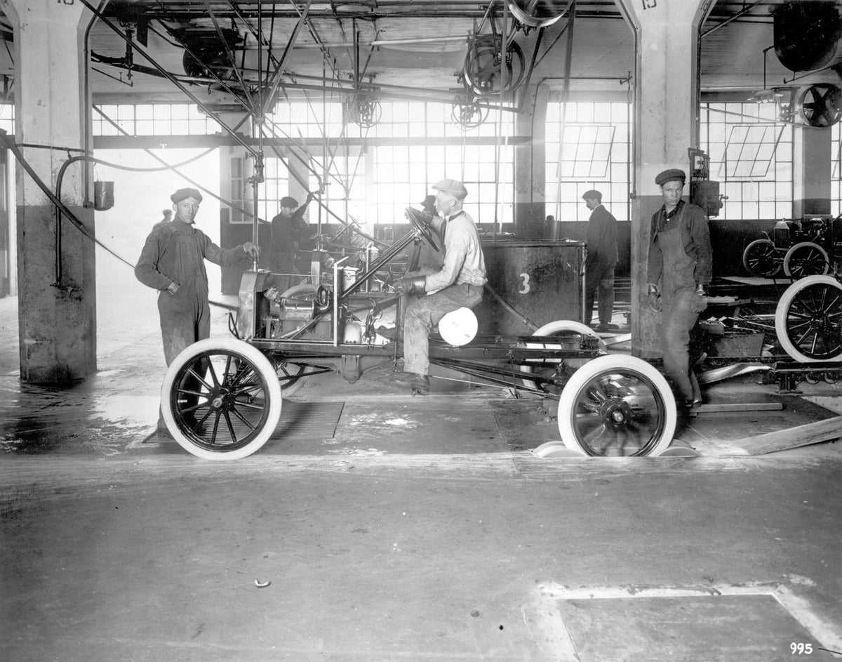 Original archival image documenting Highland Park Plant Assembly Line 1914.