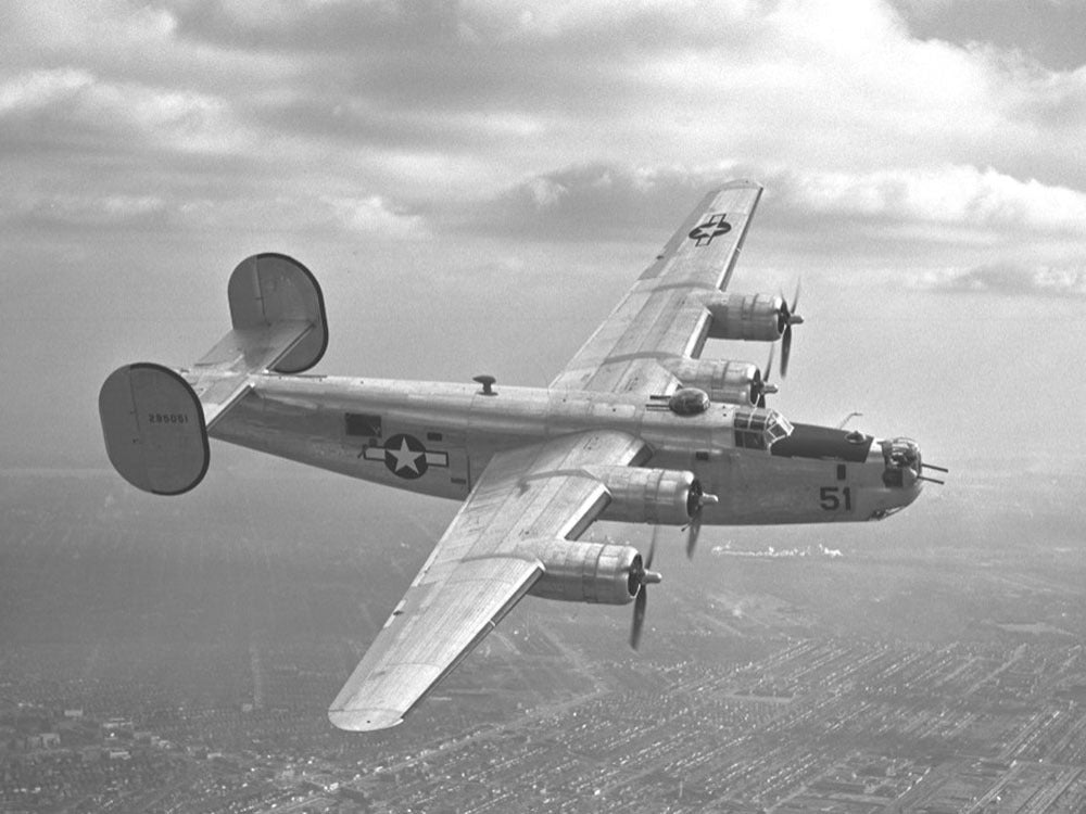 1944 February B 24 in natural finish flying over D 0400-8979