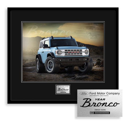 Framed photo of a blue Ford Bronco SUV with a desert background, featuring the Ford Motor Company logo.