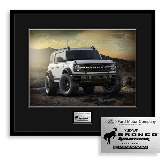 Framed photo of a white Ford Bronco SUV with a personalized plaque on a white background
