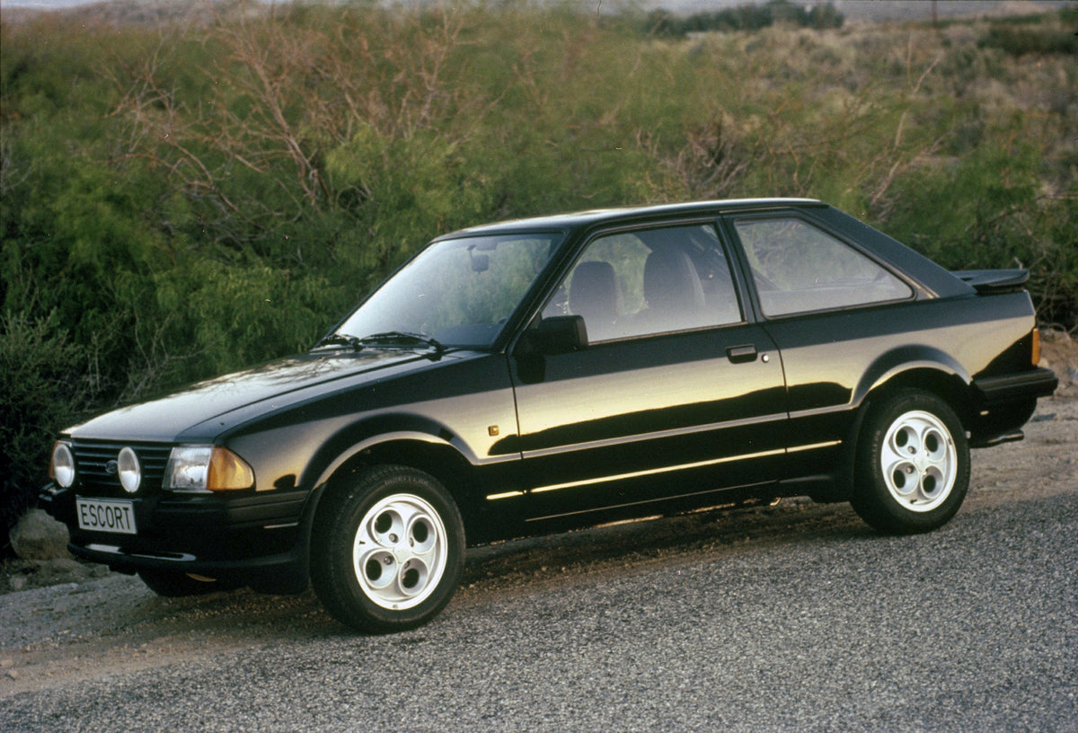 This archival image documents the 1982 Ford Escort Mark III parked on scenic road and is preserved in the Ford Heritage Vault as part of Ford Motor Company's historic photographic archive. Free for personal, non-commercial use. Ford Heritage Vault...