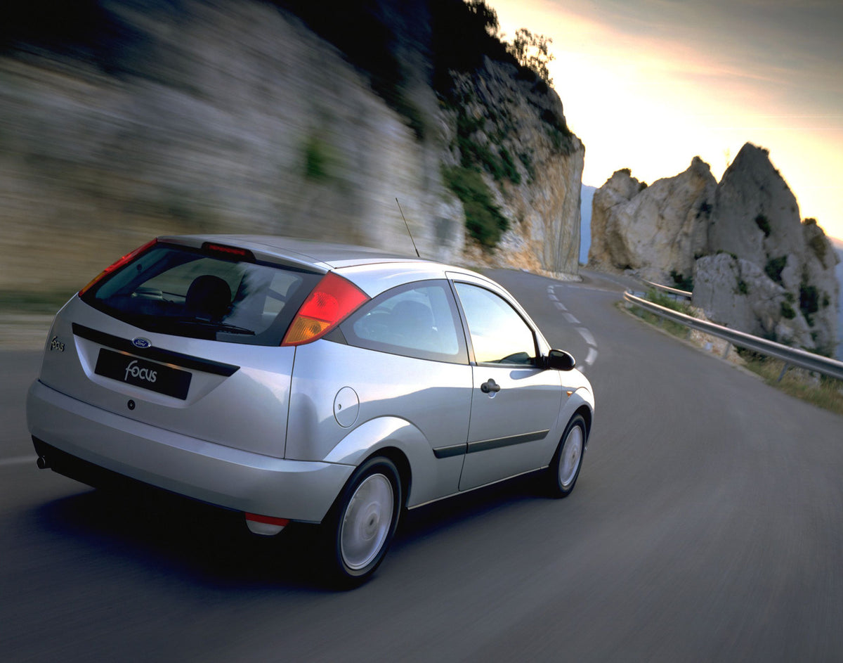 This archival image documents the 1998 Ford Focus rear view action shot on scenic mountain road and is preserved in the Ford Heritage Vault as part of Ford Motor Company's historic photographic archive. Free for personal, non-commercial use. Ford ...