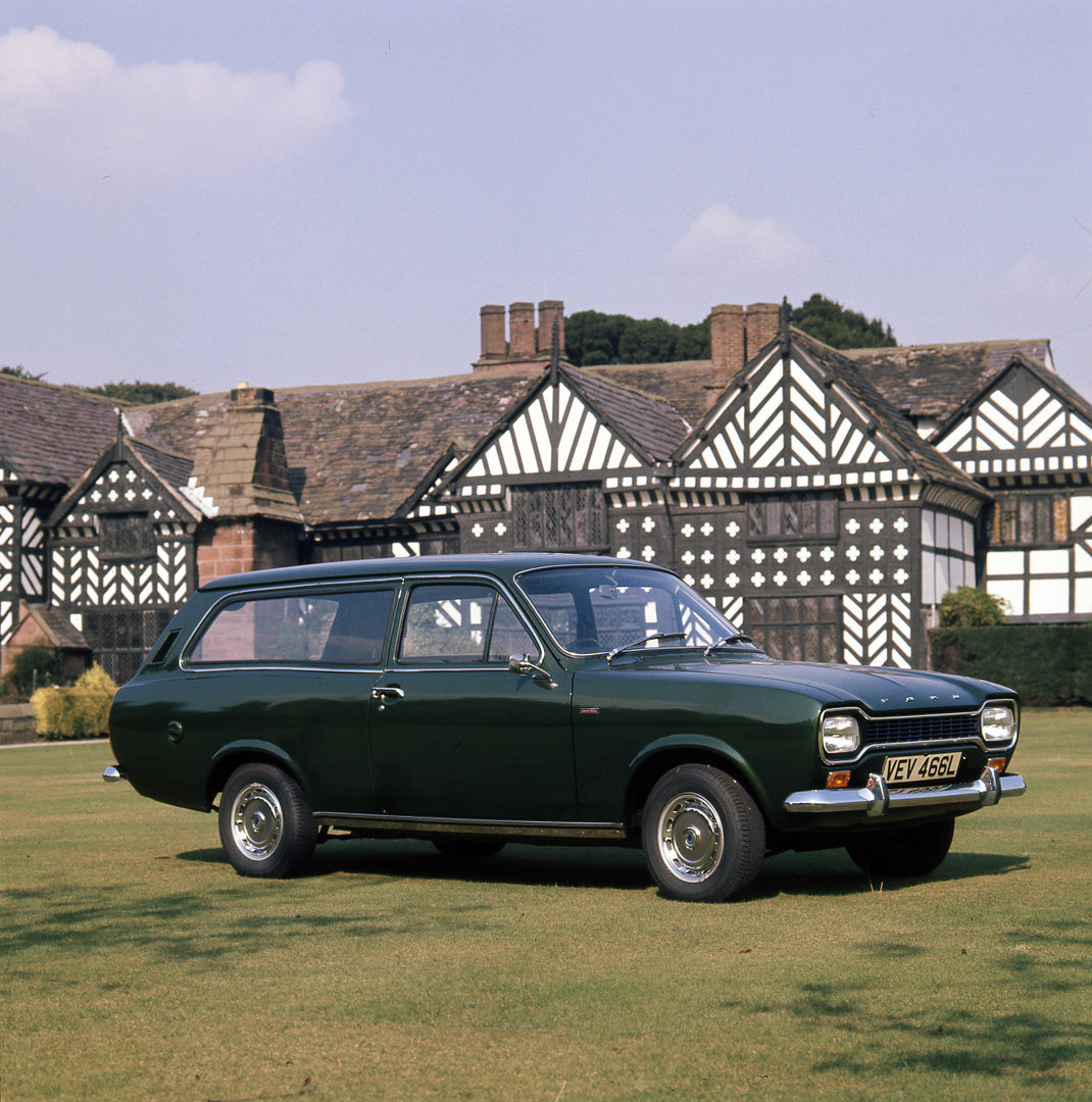 This archival image documents the 1972 Ford Escort Mark I Estate 1300 XL in front of scenic house and is preserved in the Ford Heritage Vault as part of Ford Motor Company's historic photographic archive. Free for personal, non-commercial use. For...