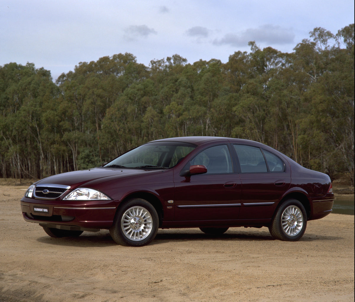 This archival image documents the 1998 Ford Fairmont Ghia on scenic dirt road with trees and is preserved in the Ford Heritage Vault as part of Ford Motor Company's historic photographic archive. Free for personal, non-commercial use. Ford Heritag...