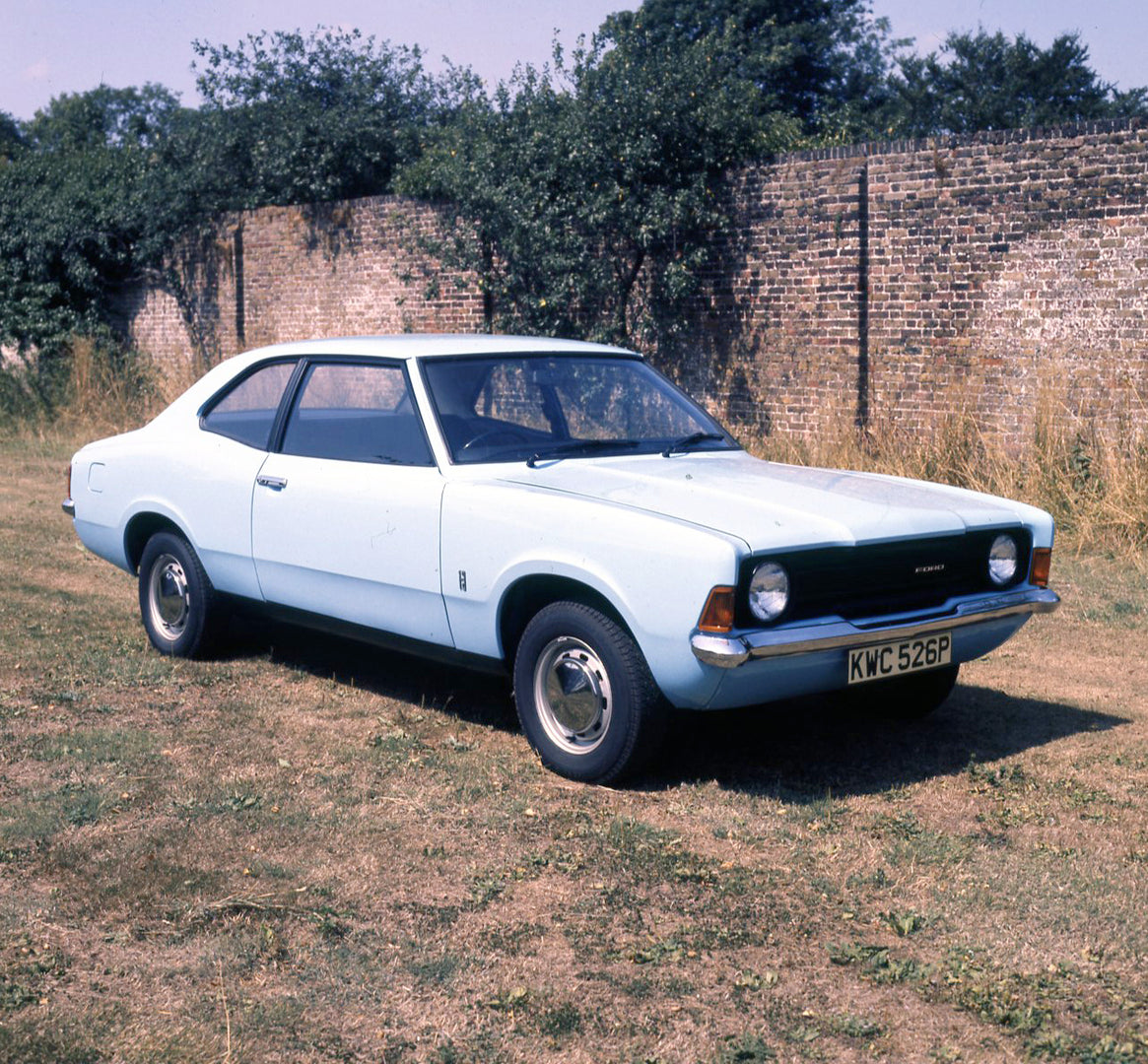 This archival image documents the 1975 Ford Cortina 1.3 Base MK III 2 door by scenic wall with shrubs and is preserved in the Ford Heritage Vault as part of Ford Motor Company's historic photographic archive. Free for personal, non-commercial use....