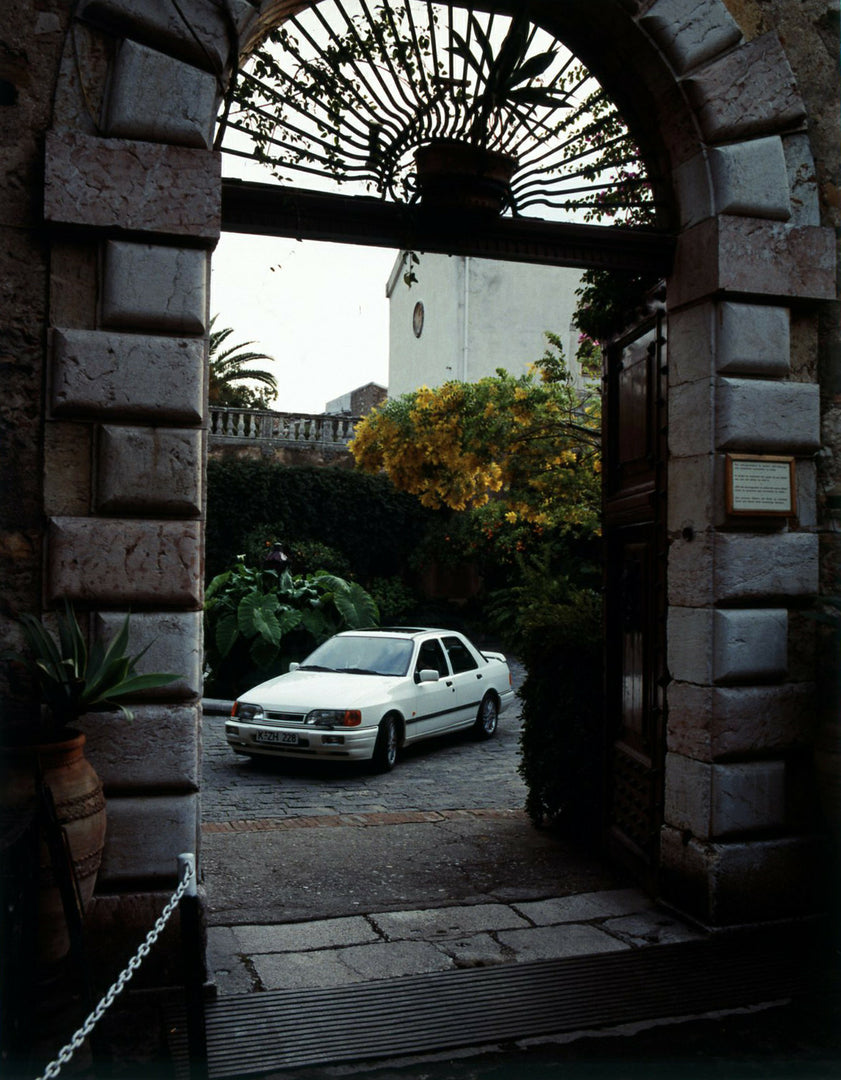 This archival image documents the 1987 Ford Sierra Cosworth LHD view through scenic archway and is preserved in the Ford Heritage Vault as part of Ford Motor Company's historic photographic archive. Free for personal, non-commercial use. Ford Heri...