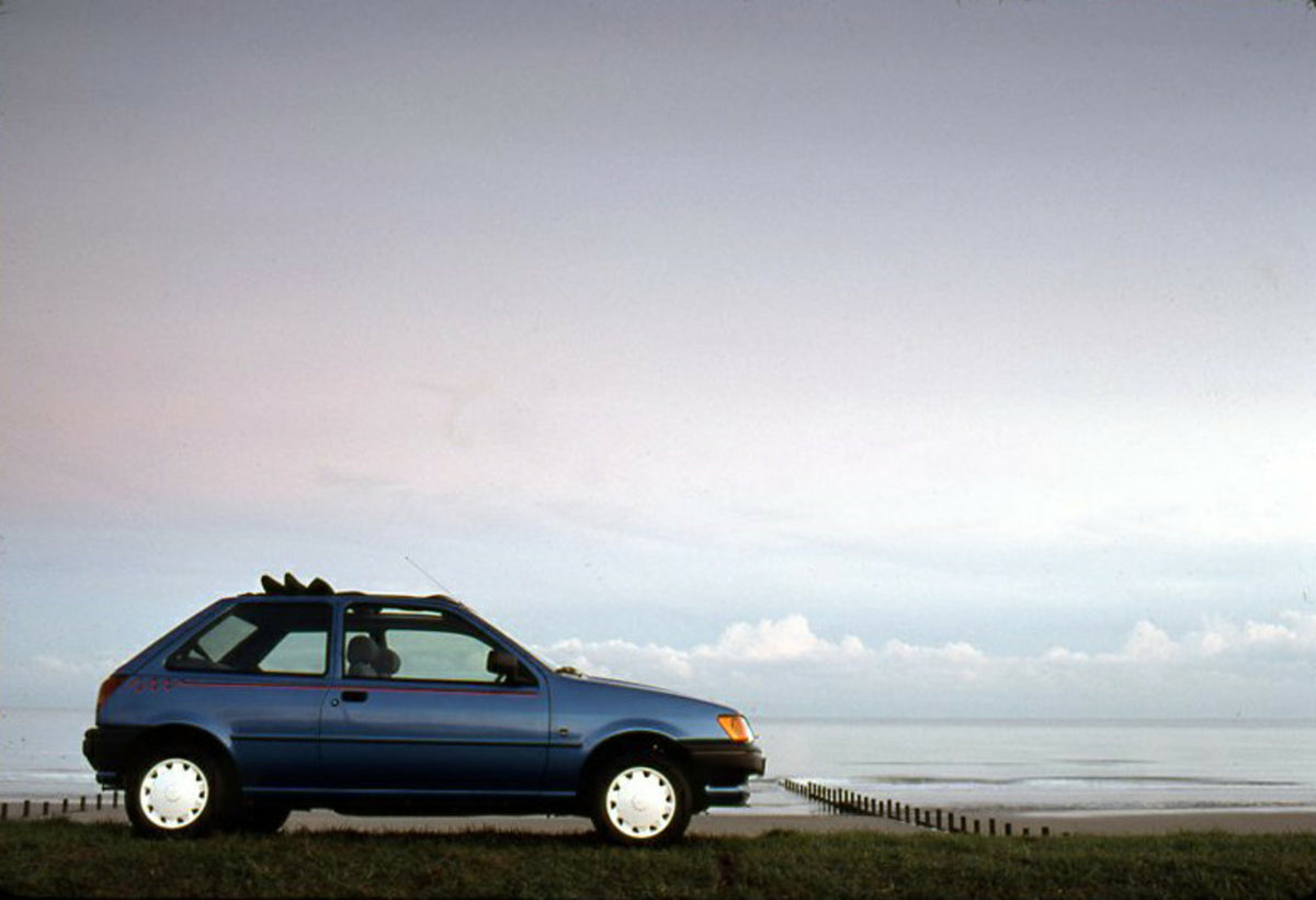 This archival image documents the 1990 Ford Fiesta Calypso LHD in field near water and is preserved in the Ford Heritage Vault as part of Ford Motor Company's historic photographic archive. Free for personal, non-commercial use. Ford Heritage Vaul...