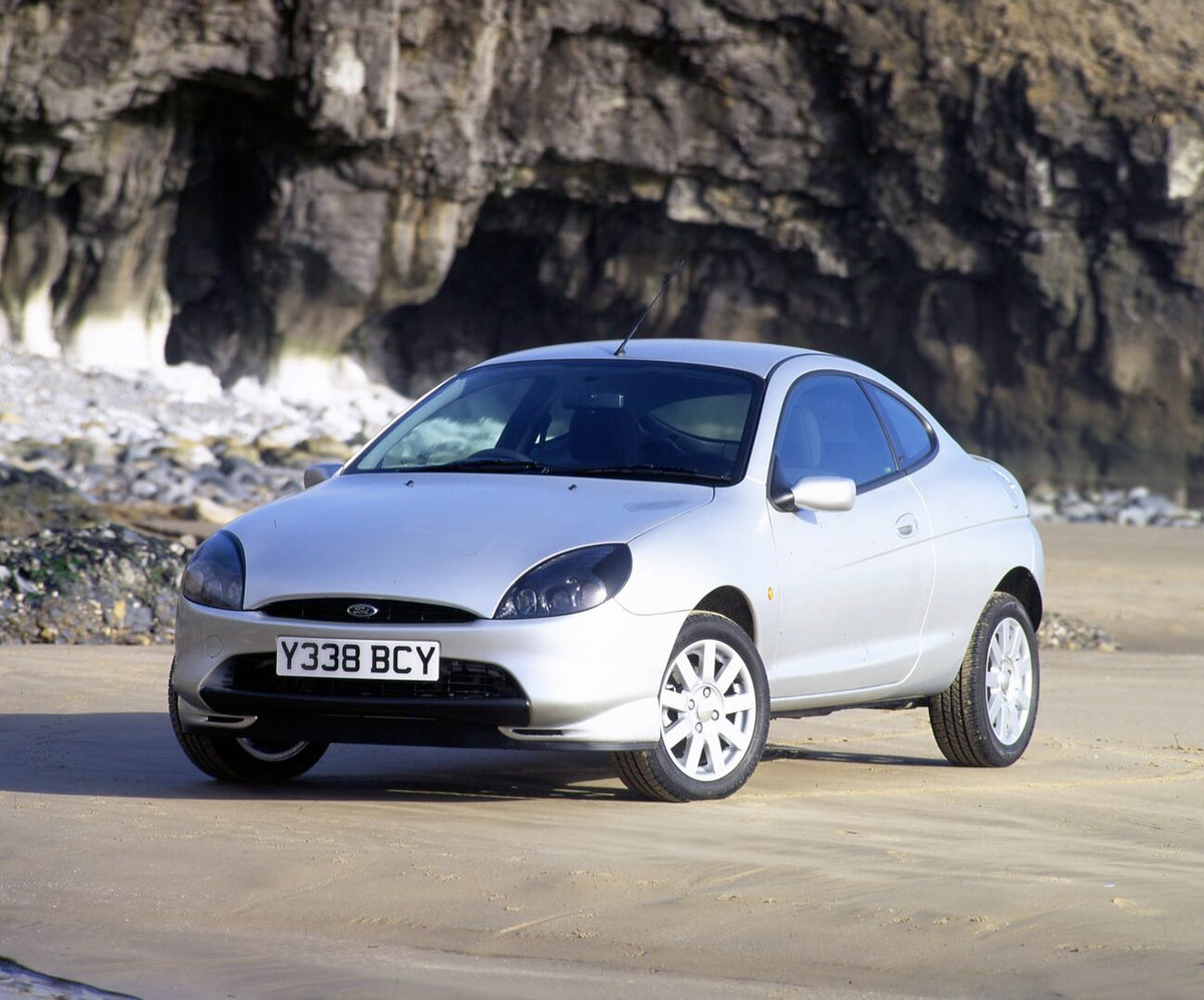 This archival image documents the 2001 Ford Puma on scenic road with cave and is preserved in the Ford Heritage Vault as part of Ford Motor Company's historic photographic archive. Free for personal, non-commercial use. Ford Heritage Vault referen...