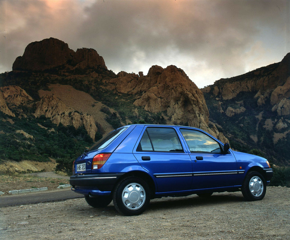This archival image documents the 1989 Ford Fiesta Mark III LHD rear view with scenic mountains and is preserved in the Ford Heritage Vault as part of Ford Motor Company's historic photographic archive. Free for personal, non-commercial use. Ford ...