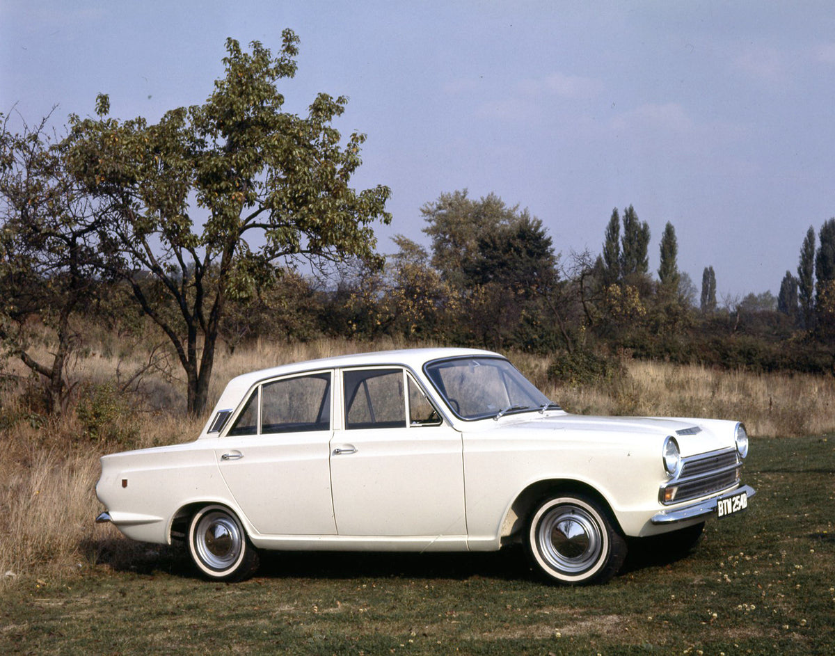 This archival image documents the 1965 Ford Cortina GT MK I side view in scenic field with trees and is preserved in the Ford Heritage Vault as part of Ford Motor Company's historic photographic archive. Free for personal, non-commercial use. Ford...