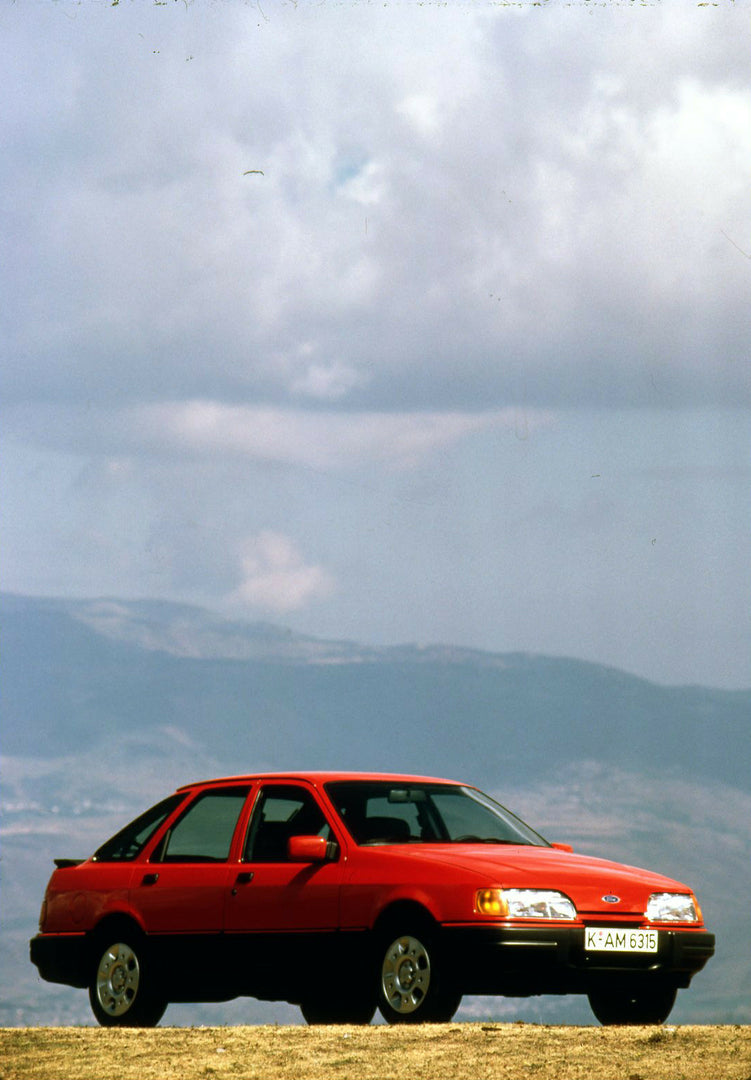 This archival image documents the 1986 Heritage Archive - 1987 1/2 Ford Sierra with scenic cloudy sky in Spain vertical shot and is preserved in the Ford Heritage Vault as part of Ford Motor Company's historic photographic archive. Free for person...