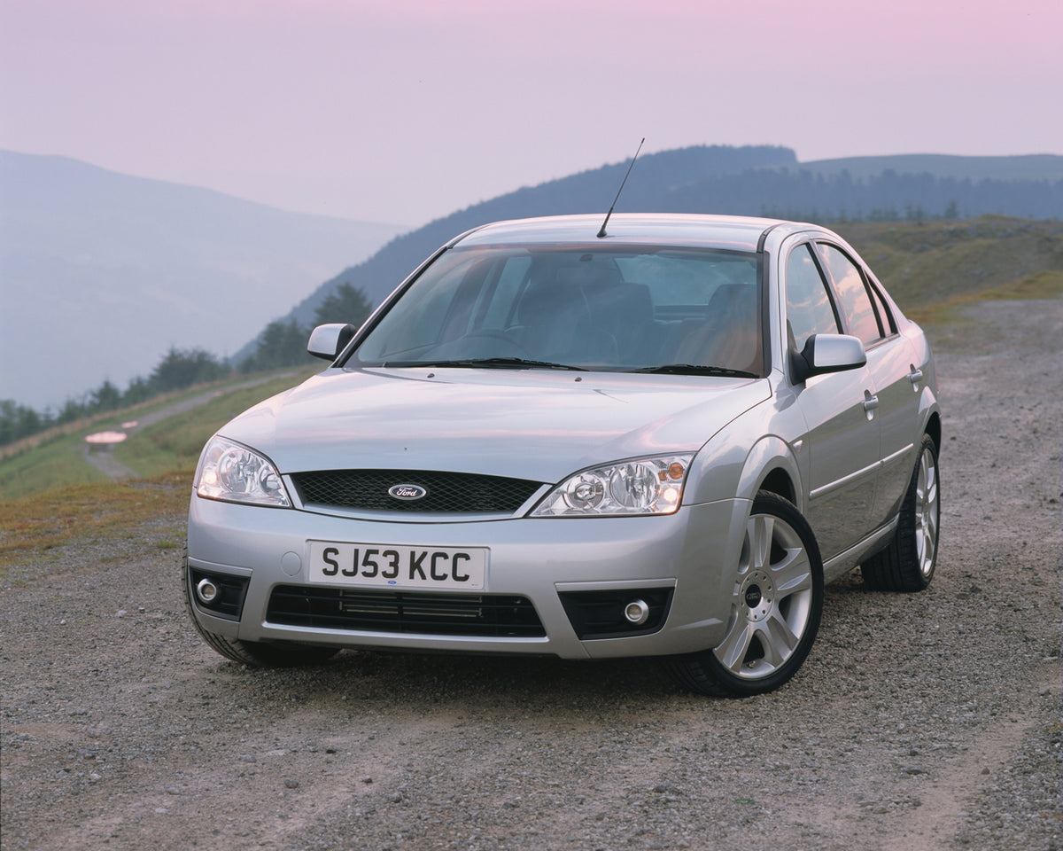 This archival image documents the 2003 Ford Mondeo Zetec Mark II on scenic road with hills and is preserved in the Ford Heritage Vault as part of Ford Motor Company's historic photographic archive. Free for personal, non-commercial use. Ford Herit...