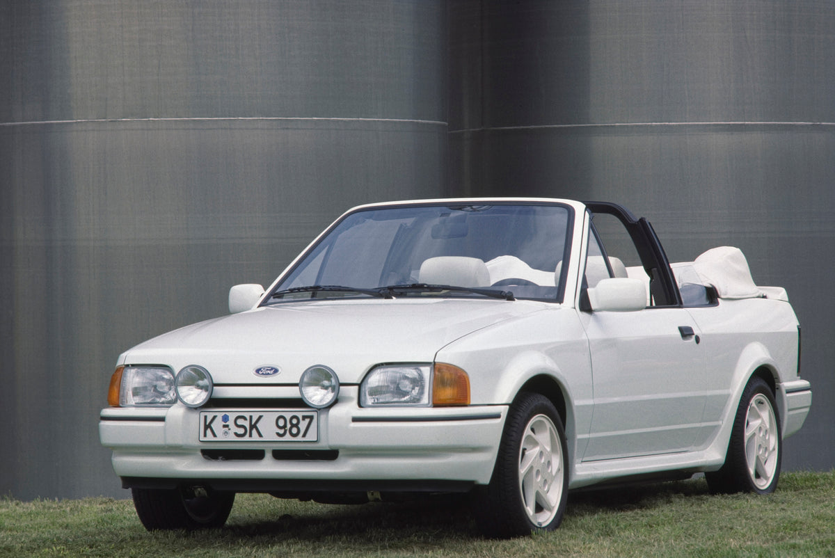 This archival image documents the 1988 Ford Escort Mark IV XR3i Cabriolet in front of scenic metal wall and is preserved in the Ford Heritage Vault as part of Ford Motor Company's historic photographic archive. Free for personal, non-commercial us...