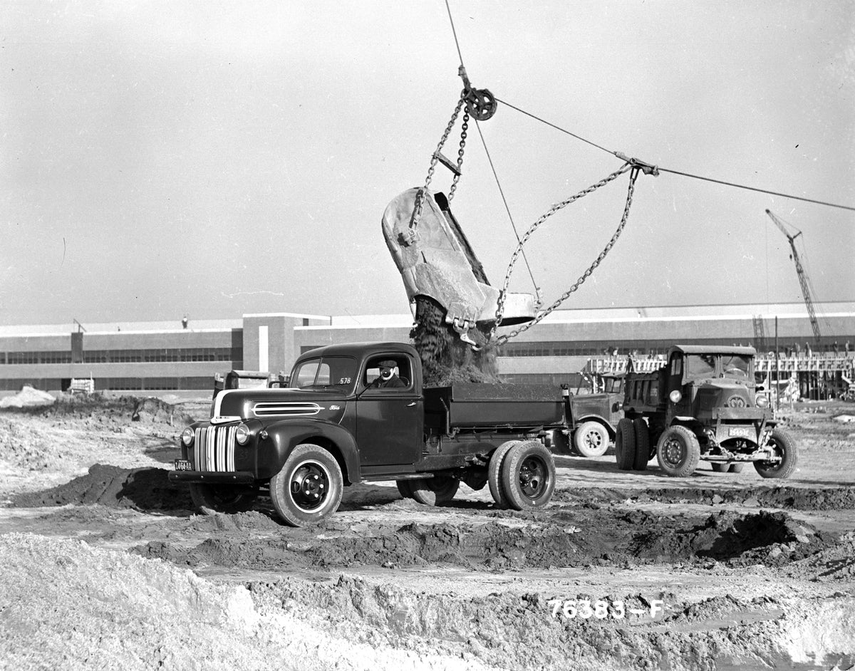 This archival image documents the 1942 Ford dump truck at construction site and is preserved in the Ford Heritage Vault as part of Ford Motor Company's historic photographic archive. Free for personal, non-commercial use. Ford Heritage Vault refer...