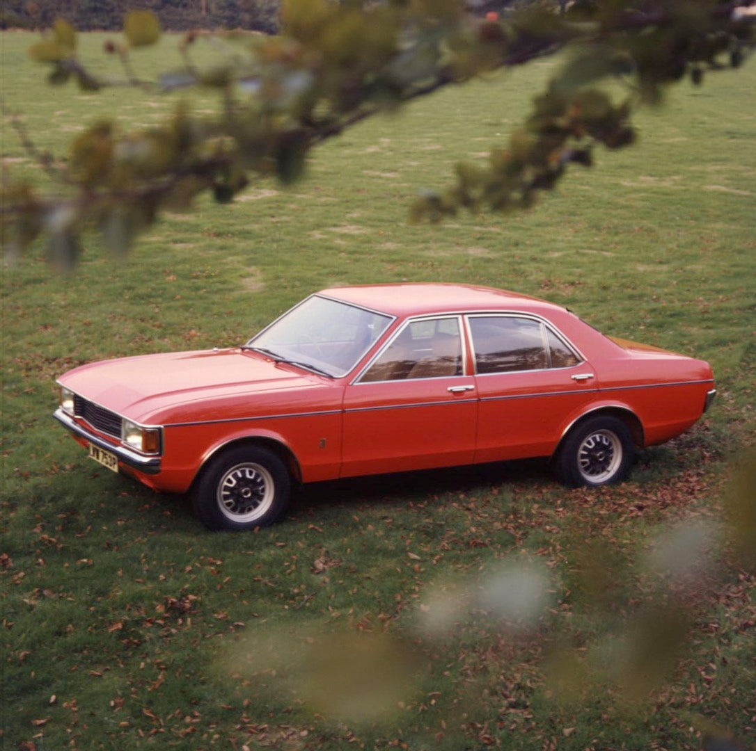 This archival image documents the 1975 Ford Granada Mark I L 2000 in scenic field through leaves and is preserved in the Ford Heritage Vault as part of Ford Motor Company's historic photographic archive. Free for personal, non-commercial use. Ford...