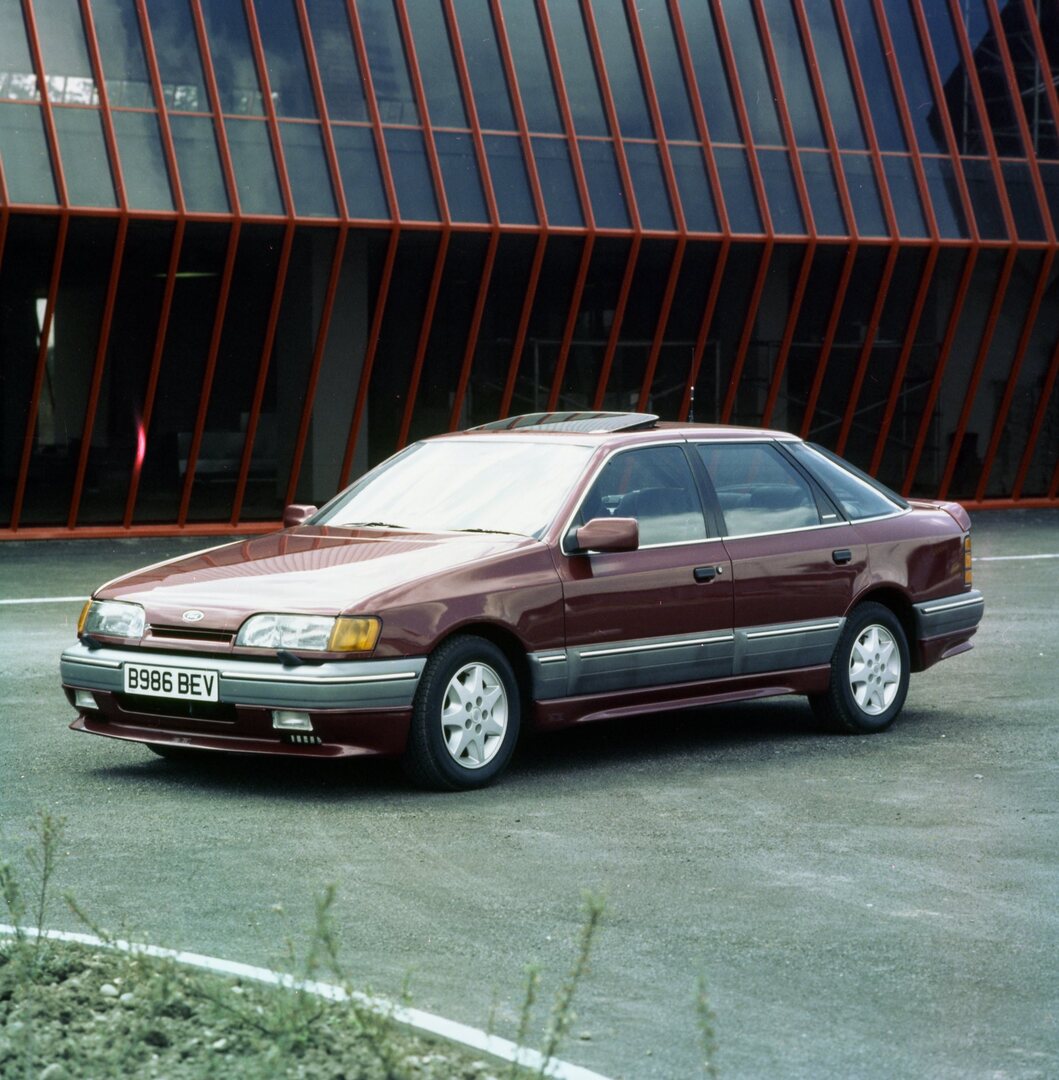 This archival image documents the 1985 Ford Granada Mark III RS in front of scenic building and is preserved in the Ford Heritage Vault as part of Ford Motor Company's historic photographic archive. Free for personal, non-commercial use. Ford Heri...