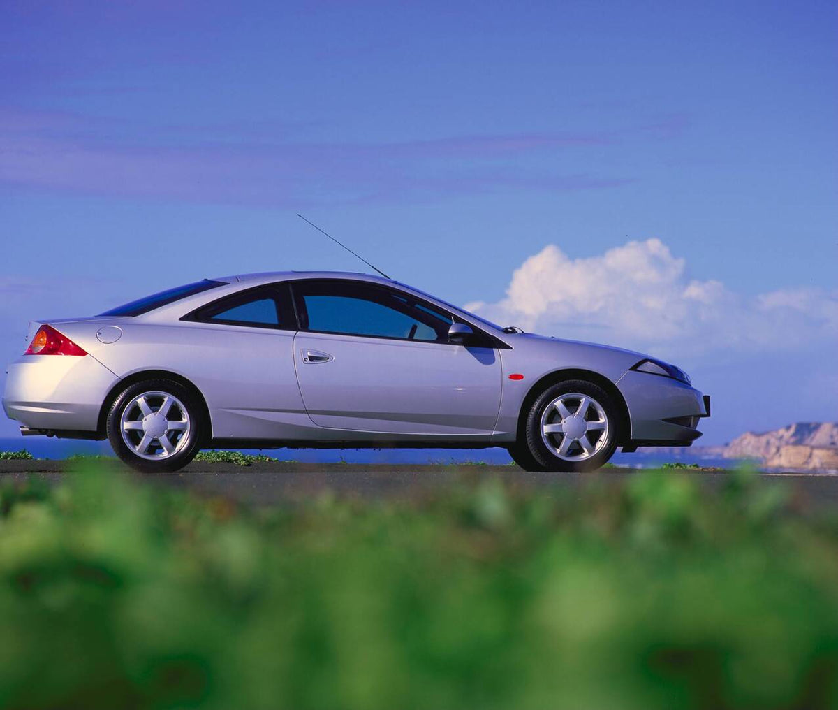 This archival image documents the 1998 Ford Cougar low side view near scenic body of water AR-2002-213709 and is preserved in the Ford Heritage Vault as part of Ford Motor Company's historic photographic archive. Free for personal, non-commercial ...