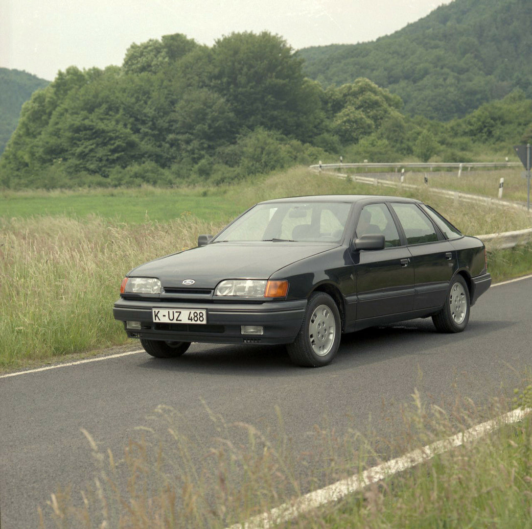 This archival image documents the 1985 Ford Scorpio Mark I 4 Wheel Drive LHD on scenic road with trees and is preserved in the Ford Heritage Vault as part of Ford Motor Company's historic photographic archive. Free for personal, non-commercial use...