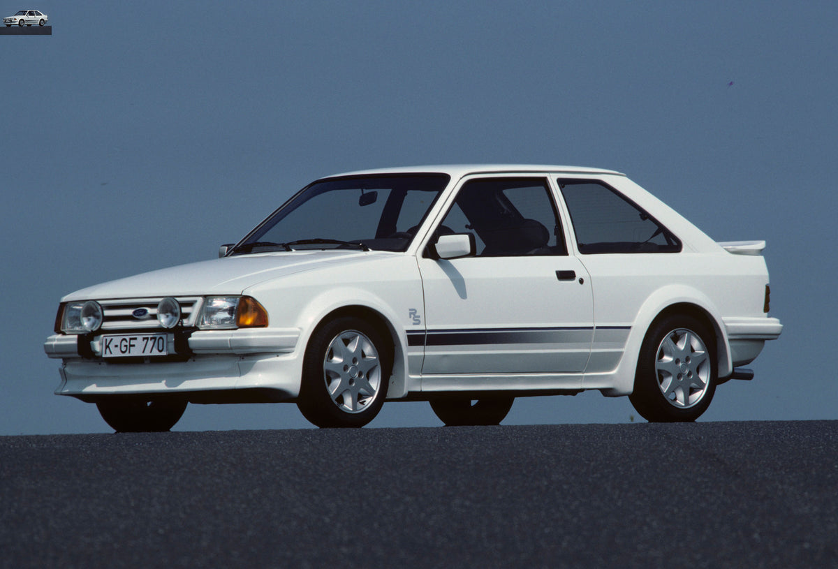 This archival image documents the 1984 Ford Escort Mark III RS Turbo with scenic blue sky and is preserved in the Ford Heritage Vault as part of Ford Motor Company's historic photographic archive. Free for personal, non-commercial use. Ford Herita...