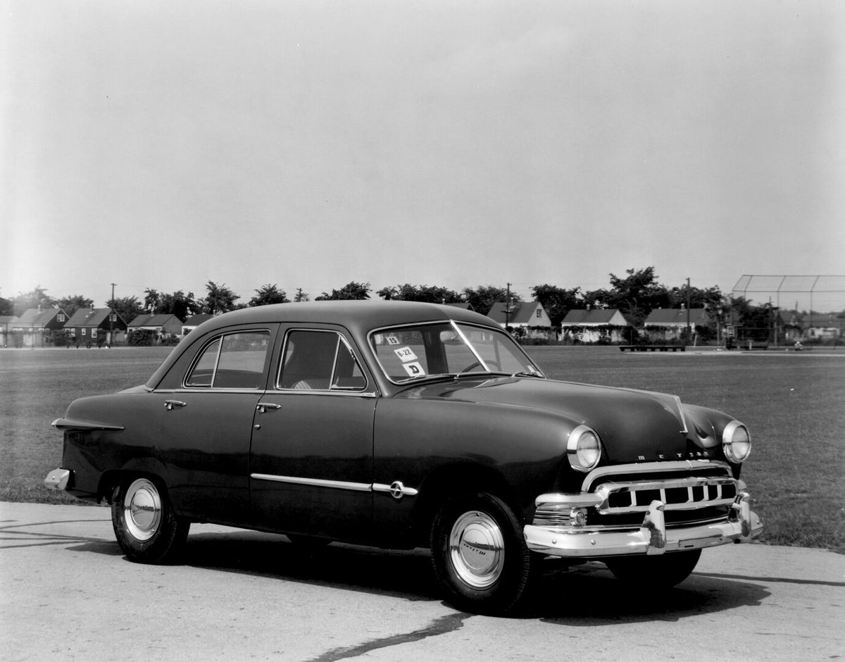 This archival image documents the 1951 Meteor Sedan on road with houses in distance AR-2007-5 and is preserved in the Ford Heritage Vault as part of Ford Motor Company's historic photographic archive. Free for personal, non-commercial use. Ford He...