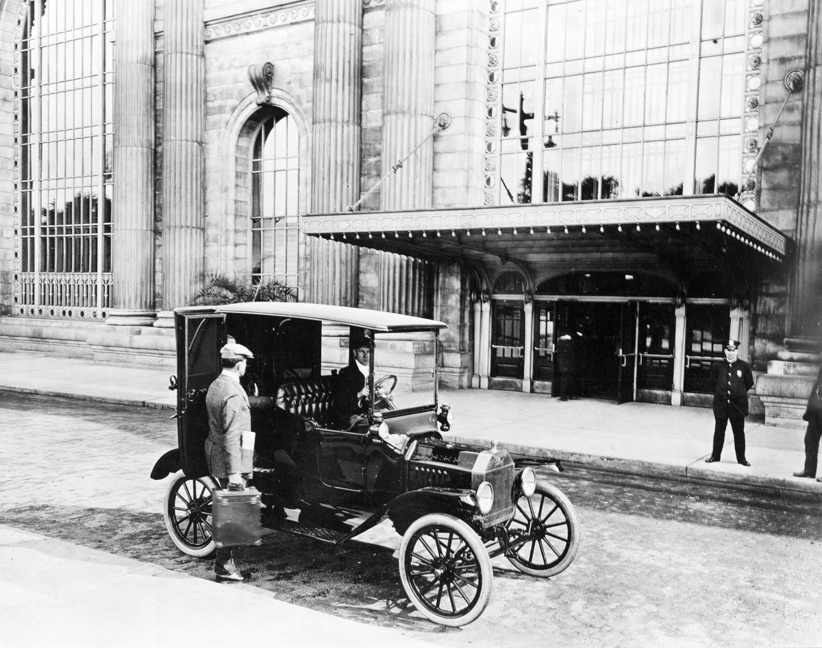 This archival image documents the 1915 Ford Model T Town Car at Michigan Central Station in Detroit and is preserved in the Ford Heritage Vault as part of Ford Motor Company's historic photographic archive. Free for personal, non-commercial use. F...