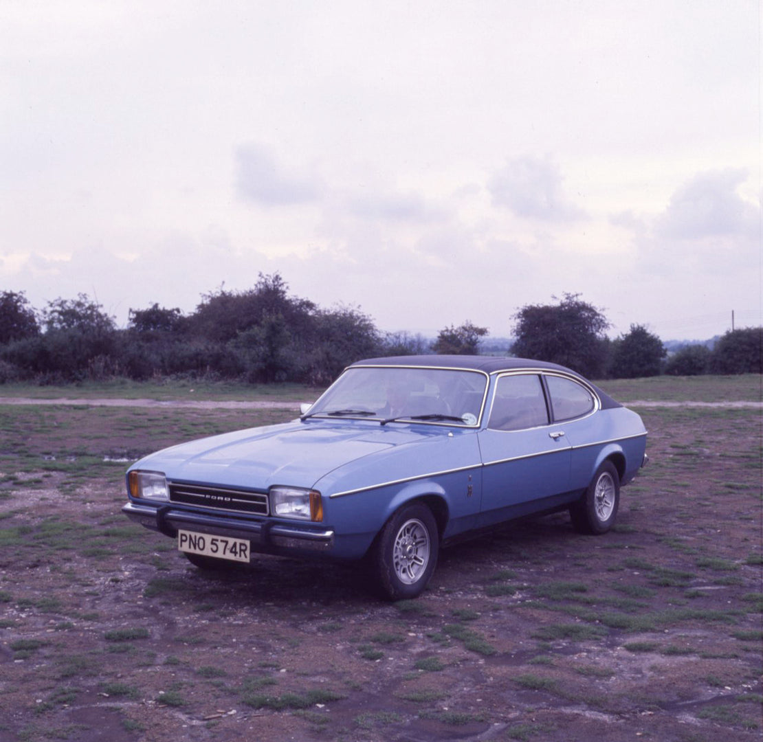 This archival image documents the 1976 Ford Capri Ghia in scenic field with trees and is preserved in the Ford Heritage Vault as part of Ford Motor Company's historic photographic archive. Free for personal, non-commercial use. Ford Heritage Vault...