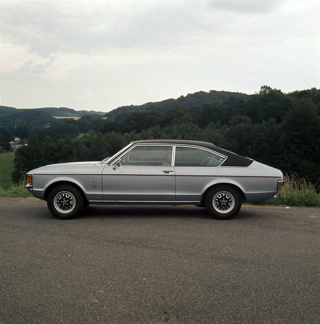 This archival image documents the 1974 Ford Granada Mark I side view on scenic road with trees and is preserved in the Ford Heritage Vault as part of Ford Motor Company's historic photographic archive. Free for personal, non-commercial use. Ford H...
