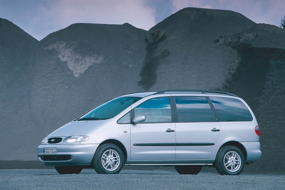 This archival image documents the 1999 Ford Galaxy side view on gravel road with scenic hills and is preserved in the Ford Heritage Vault as part of Ford Motor Company's historic photographic archive. Free for personal, non-commercial use. Ford He...
