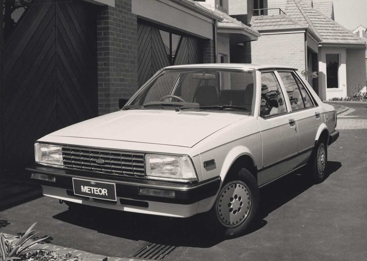 This archival image documents the 1983 Ford GA Meteor Sedan Passenger Side Front End View in Driveway FAP-2011-3 and is preserved in the Ford Heritage Vault as part of Ford Motor Company's historic photographic archive. Free for personal, non-comm...