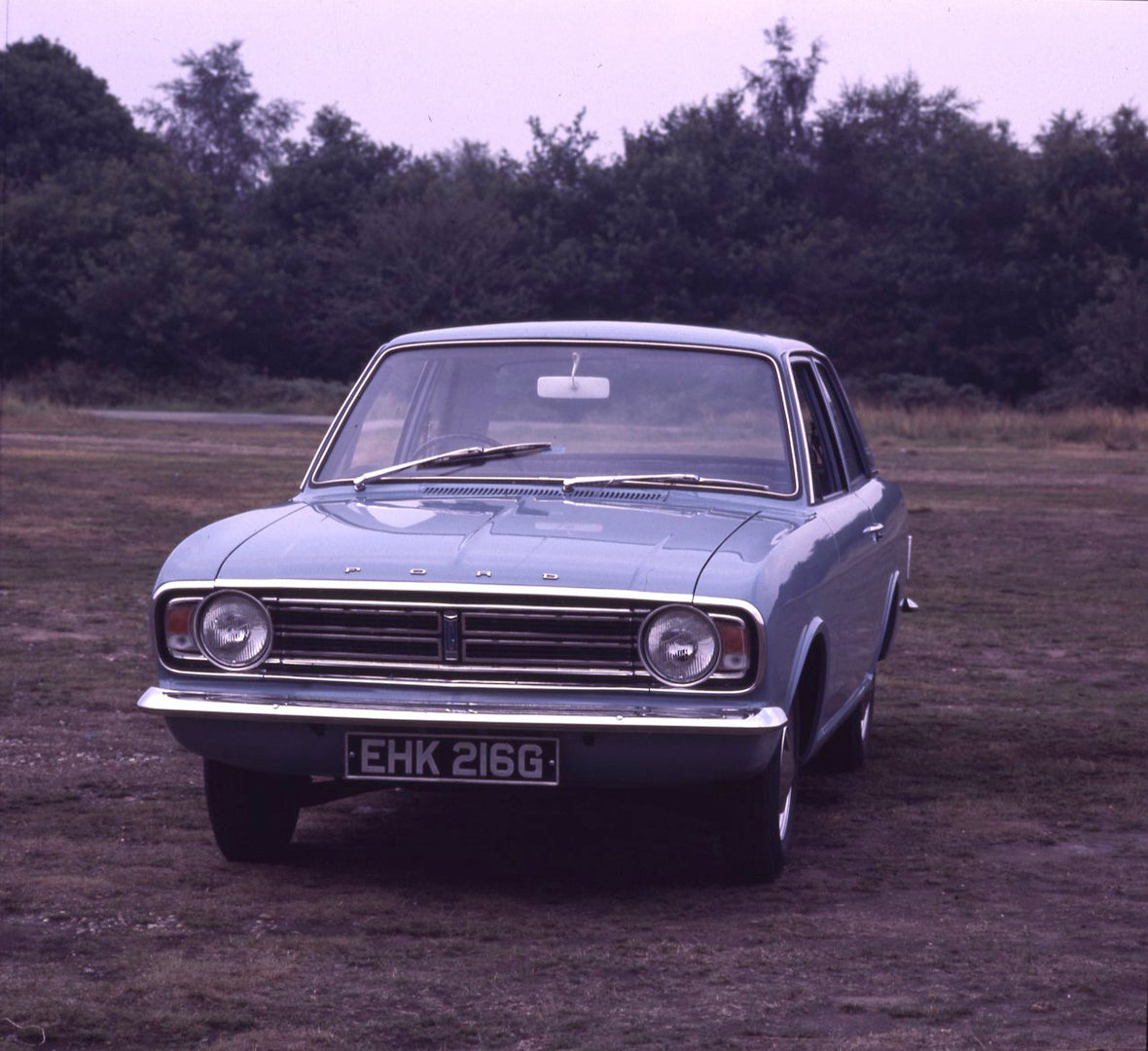 This archival image documents the 1969 Ford Cortina MK II DL 1300 2 door front view in scenic field with trees and is preserved in the Ford Heritage Vault as part of Ford Motor Company's historic photographic archive. Free for personal, non-commer...