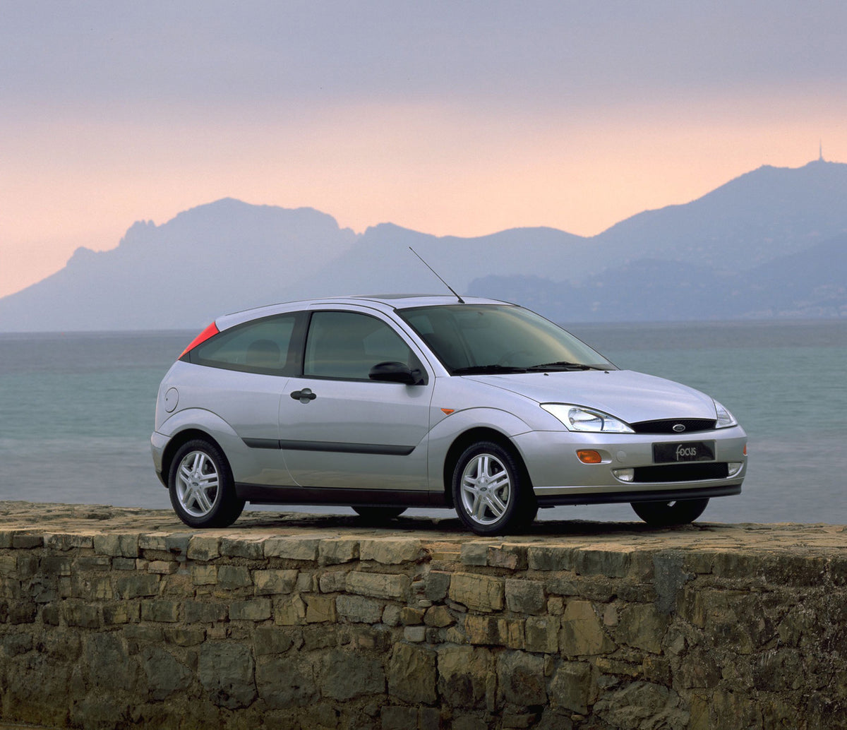 This archival image documents the 1998 Ford Focus with scenic mountains and body of water and is preserved in the Ford Heritage Vault as part of Ford Motor Company's historic photographic archive. Free for personal, non-commercial use. Ford Herita...