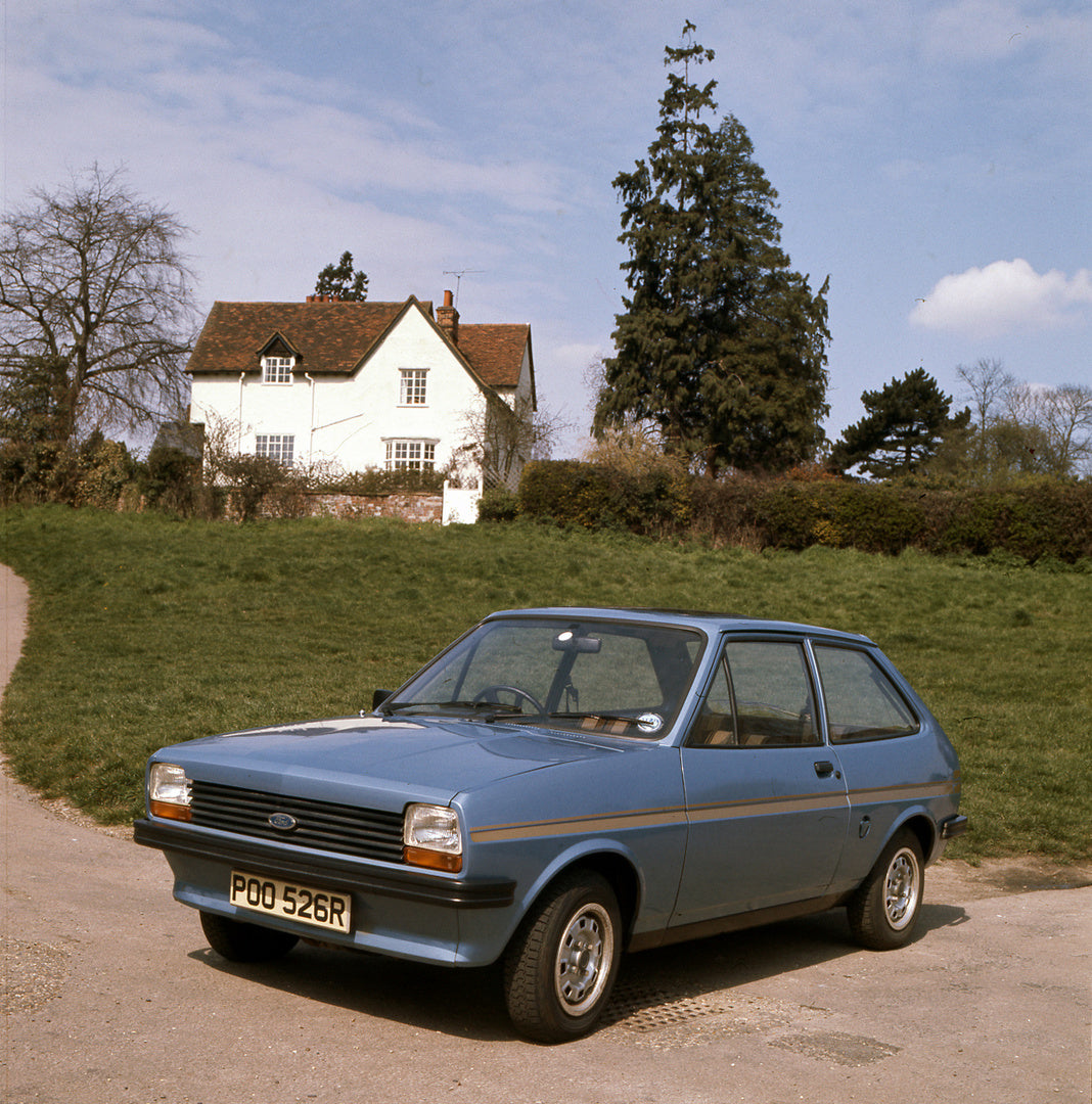 This archival image documents the 1977 Ford Fiesta Mark I S in front of scenic house and is preserved in the Ford Heritage Vault as part of Ford Motor Company's historic photographic archive. Free for personal, non-commercial use. Ford Heritage Va...