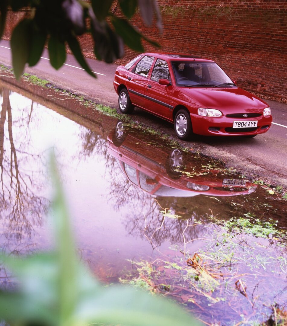 This archival image documents the 1999 Ford Escort Mark VI Flight on scenic road with brick wall and is preserved in the Ford Heritage Vault as part of Ford Motor Company's historic photographic archive. Free for personal, non-commercial use. Ford...